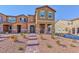 Charming townhome with stone accents, a brick walkway, and desert landscaping at 2887 Starling Summit St, Henderson, NV 89044