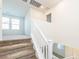 Staircase with white banister leading to the upper level, showcasing neutral decor at 2887 Starling Summit St, Henderson, NV 89044