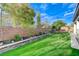 This backyard features artificial turf, custom planters, and a relaxing seating area perfect for entertaining at 3144 Tronzano Ave, Henderson, NV 89044