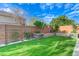 Private backyard showcasing artificial turf, custom wall planters, and ample space for entertainment at 3144 Tronzano Ave, Henderson, NV 89044