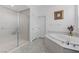 Elegant bathroom includes a glass-enclosed shower and a soaking tub with marble surround at 3144 Tronzano Ave, Henderson, NV 89044