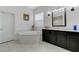 Bright bathroom features a built-in tub with elegant marble accents and fixtures at 3144 Tronzano Ave, Henderson, NV 89044