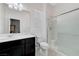 Well-lit bathroom featuring a vanity sink, toilet, and glass-enclosed shower at 3144 Tronzano Ave, Henderson, NV 89044