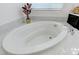 Close-up of a modern soaking tub with marble surround and sleek chrome fixtures at 3144 Tronzano Ave, Henderson, NV 89044