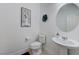 Half-bathroom with unique decor, a sleek sink, and toilet at 3144 Tronzano Ave, Henderson, NV 89044