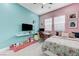 Bright bedroom with unique decor, a workspace, plushies, and floral bedding at 3144 Tronzano Ave, Henderson, NV 89044