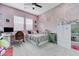 Charming bedroom with a decorative wall, floral bedding, a workspace, and built-in shelves at 3144 Tronzano Ave, Henderson, NV 89044