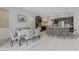 Open dining and kitchen area with black cabinetry and a spacious island, great for entertaining or daily living at 3144 Tronzano Ave, Henderson, NV 89044
