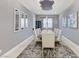 Elegant dining room with seating for ten, unique ceiling feature, and wall art at 3144 Tronzano Ave, Henderson, NV 89044