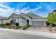 Attractive single story home boasting manicured landscaping and a gray two-car garage at 3144 Tronzano Ave, Henderson, NV 89044