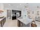 Bright kitchen with stainless steel appliances, granite countertops, and a curved island with seating for casual dining at 3144 Tronzano Ave, Henderson, NV 89044