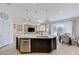 Open floorplan showing kitchen island, dining area, and living room, all naturally lit with nice decor and finishes at 3144 Tronzano Ave, Henderson, NV 89044