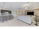 Open living space with kitchen, comfortable sofa, and modern appliances at 3144 Tronzano Ave, Henderson, NV 89044
