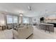 Open-concept living room with kitchen island, comfortable seating, and natural light at 3144 Tronzano Ave, Henderson, NV 89044