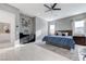 This spacious main bedroom boasts a black console with art wall and light wood flooring at 3144 Tronzano Ave, Henderson, NV 89044