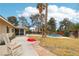 The inviting backyard boasts mature trees, lush lawn, a relaxing pool area, and ample space for outdoor living at 3155 Duneville St, Las Vegas, NV 89146