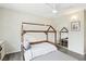 Charming bedroom with wood-look floors, ceiling fan, and a unique house frame bed with white bedding at 3155 Duneville St, Las Vegas, NV 89146