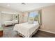 Serene bedroom with wood-look floors, a mirrored closet, and plenty of natural light at 3155 Duneville St, Las Vegas, NV 89146