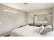 Bright bedroom with white walls, a large mirrored closet, and modern lighting fixtures at 3155 Duneville St, Las Vegas, NV 89146