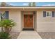 Inviting front entrance with double doors, stone accents, and drought-resistant landscaping at 3155 Duneville St, Las Vegas, NV 89146