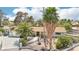 Attractive single-story home featuring mature palm trees, a desert landscape and a gated driveway at 3155 Duneville St, Las Vegas, NV 89146