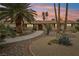 Charming home with lush landscaping, stone accents, and a welcoming walkway at sunset at 3155 Duneville St, Las Vegas, NV 89146