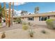 Expansive front yard featuring mature trees, gravel landscaping, and desert plants at 3155 Duneville St, Las Vegas, NV 89146