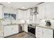 Stylish kitchen with white cabinetry, stainless steel appliances, and granite countertops at 3155 Duneville St, Las Vegas, NV 89146