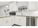 Modern kitchen with white cabinets, stainless appliances, granite counters, and natural light at 3155 Duneville St, Las Vegas, NV 89146