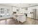 Bright kitchen with white cabinets, granite counters, stainless steel appliances, and backyard access at 3155 Duneville St, Las Vegas, NV 89146
