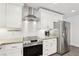 Updated kitchen with stainless steel appliances, granite counters, and sleek white cabinets at 3155 Duneville St, Las Vegas, NV 89146