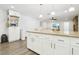 Open-concept kitchen featuring a large island, white cabinetry, and stainless steel appliances at 3155 Duneville St, Las Vegas, NV 89146