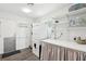 Functional laundry room with washer, dryer, storage shelves, and a folding table at 3155 Duneville St, Las Vegas, NV 89146