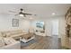 Bright and open living room featuring modern decor, wood floors, and a stone fireplace with a cozy seating area at 3155 Duneville St, Las Vegas, NV 89146