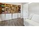 Cozy living room with built-in bookshelves, wood-look floors and neutral colored walls at 3155 Duneville St, Las Vegas, NV 89146
