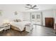 Bright bedroom boasts wood-look floors, a ceiling fan, white walls, and access to the yard at 3155 Duneville St, Las Vegas, NV 89146