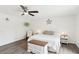 Bright bedroom with a ceiling fan, wood-look floors, white walls, and hanging plants at 3155 Duneville St, Las Vegas, NV 89146