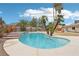 Inviting backyard pool with spa, palm trees, and a blue sky creating an ideal oasis for relaxation and entertainment at 3155 Duneville St, Las Vegas, NV 89146