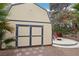 Large shed in backyard with seating area creating a private retreat with ample storage and outdoor space at 3155 Duneville St, Las Vegas, NV 89146