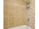 Bathtub shower combo with decorative tile surround at 3155 Duneville St, Las Vegas, NV 89146