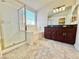This bathroom features a bathtub, a glass-enclosed shower, and a double sink vanity at 3919 Lilac Haze St, Las Vegas, NV 89147