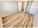 Bright bedroom featuring wood-look flooring, closet with double doors, and a neutral color palette at 3919 Lilac Haze St, Las Vegas, NV 89147