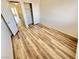 A bright bedroom with light wood floors, double door closet, and fresh neutral paint provides modern comfort at 3919 Lilac Haze St, Las Vegas, NV 89147