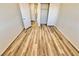 An empty bedroom showcases light wood flooring, double door closet, and freshly painted neutral walls at 3919 Lilac Haze St, Las Vegas, NV 89147