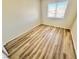 Well-lit, empty bedroom featuring wood-look floors and a window with bright natural light at 3919 Lilac Haze St, Las Vegas, NV 89147