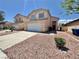 Tan two-story home with a two-car garage and low-maintenance rock landscaping at 3919 Lilac Haze St, Las Vegas, NV 89147