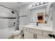 Bathroom featuring a shower-tub combo, vanity, and decorative mirror at 4200 S Valley View Blvd # 2085, Las Vegas, NV 89103