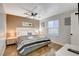Bedroom with a ceiling fan, bed with striped linens and natural lighting at 4200 S Valley View Blvd # 2085, Las Vegas, NV 89103