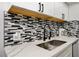 Kitchen detail featuring backsplash, countertops, and stainless steel sink at 4200 S Valley View Blvd # 2085, Las Vegas, NV 89103