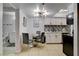 Well-lit kitchen and dining area featuring white cabinets and a modern light fixture at 4200 S Valley View Blvd # 2085, Las Vegas, NV 89103